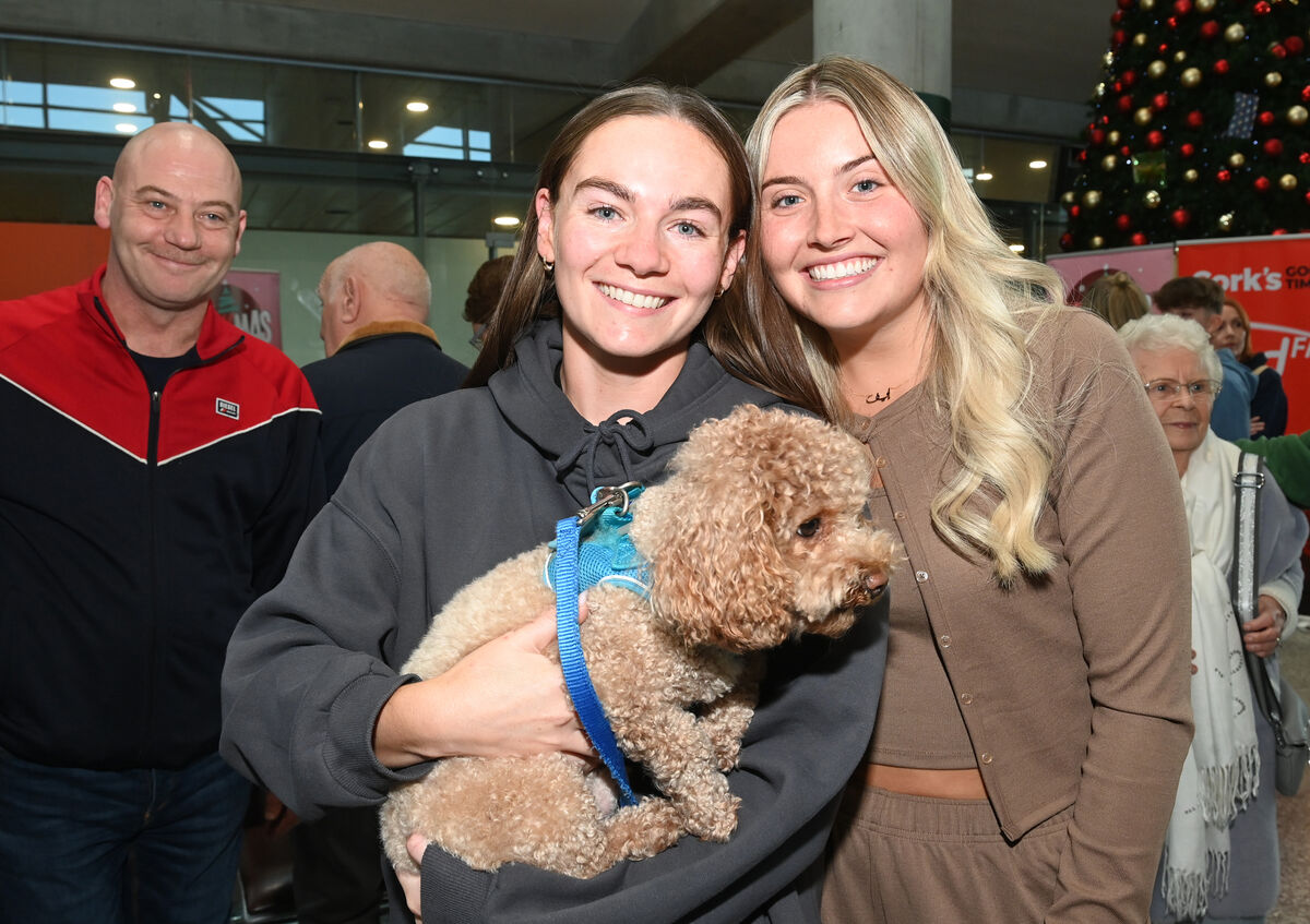 Best friends Kelly Matthews and Eve Mullins with Kelly's dog Bear who made the trip to Cork Airport for their arrival from Dubai. Pictures: Larry Cummins