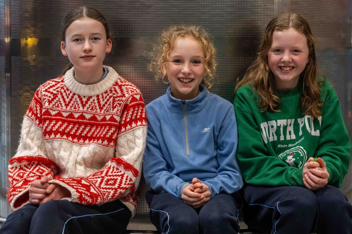 Evie Kelly and Rosa &amp; Anna O'Driscoll waiting patiently at Cork Airport for the arrival home of their uncle Vince. Picture: Andy Gibson