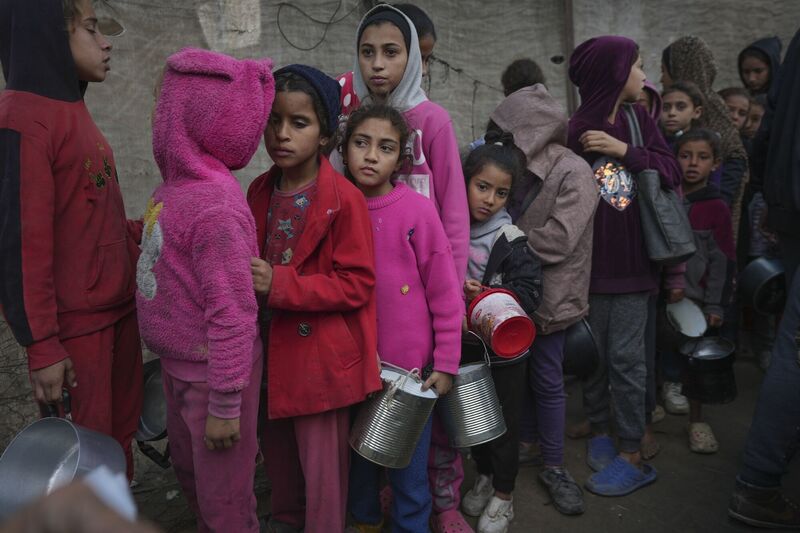 Palestinian children queue at a food distribution kitchen in Deir al-Balah, Gaza Strip, on November 28, 2024. Picture: Abdel Kareem Hana/AP Palestinian children queue at a food distribution kitchen in Deir al-Balah, Gaza Strip, on November 28, 2024. Picture: Abdel Kareem Hana/AP
