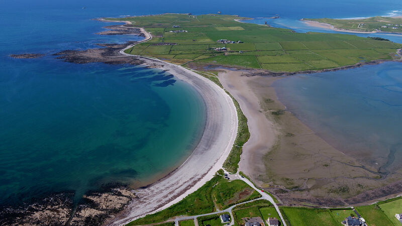 The length of the sandbar is 600m on the east side and 800m on its western side, and when the tide is low it is a popular walking route from mainland to island and back for tourists and locals alike. Picture: Domnick Walsh 
