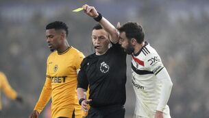 <p>SMELLS OFF: Manchester United's Bruno Fernandes (right) confronts referee Tony Harrington (centre) after being shown a yellow card during the Premier League match at Molineux Stadium, Wolverhampton. Pic: Nick Potts/PA Wire.</p>