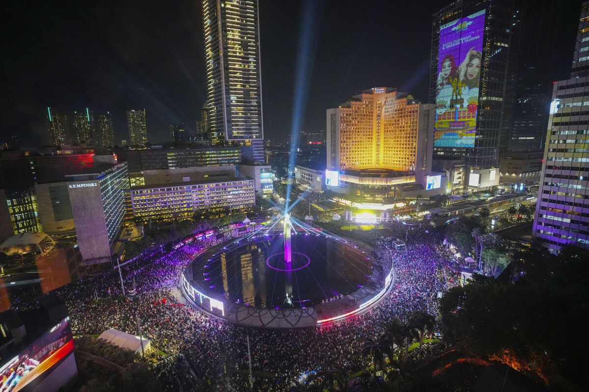 People gather in the main business district on New Year's Eve in Jakarta, Indonesia on Tuesday Picture: AP Photo/Tatan Syuflana