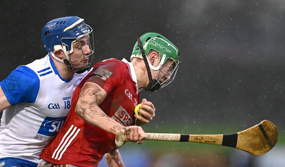 Ben Cunningham of Cork is tackled by Sam Fitzgerald of Waterford. 