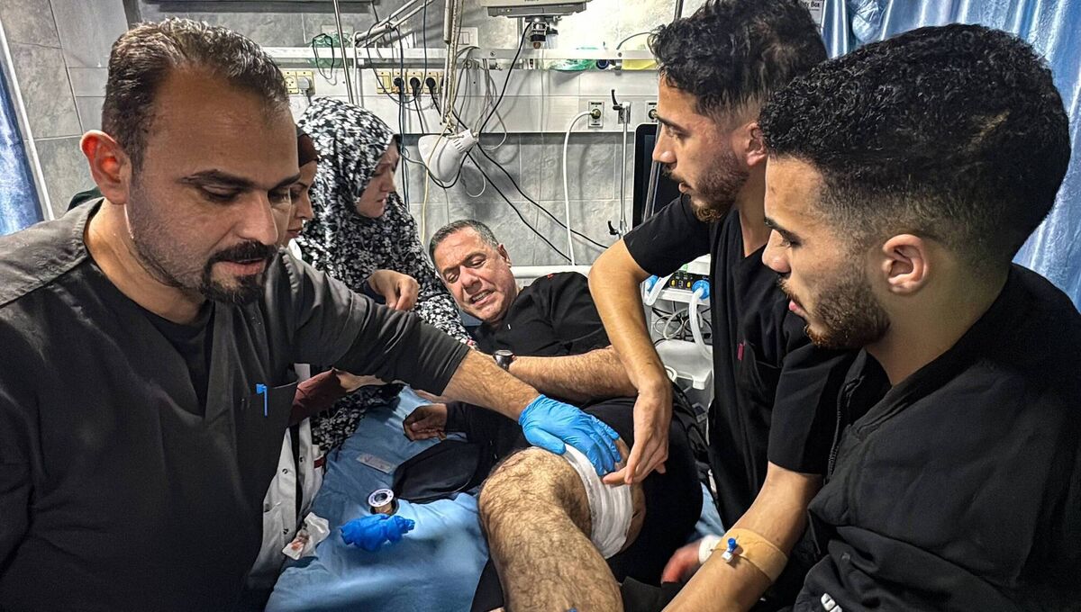 Hussam Abu Safiya is treated by colleagues for his injuries following an Israeli strike hit the medical compound in Beit Lahia, in the northern Gaza Strip, late on November 23, 2024. Picture: AFP via Getty Images