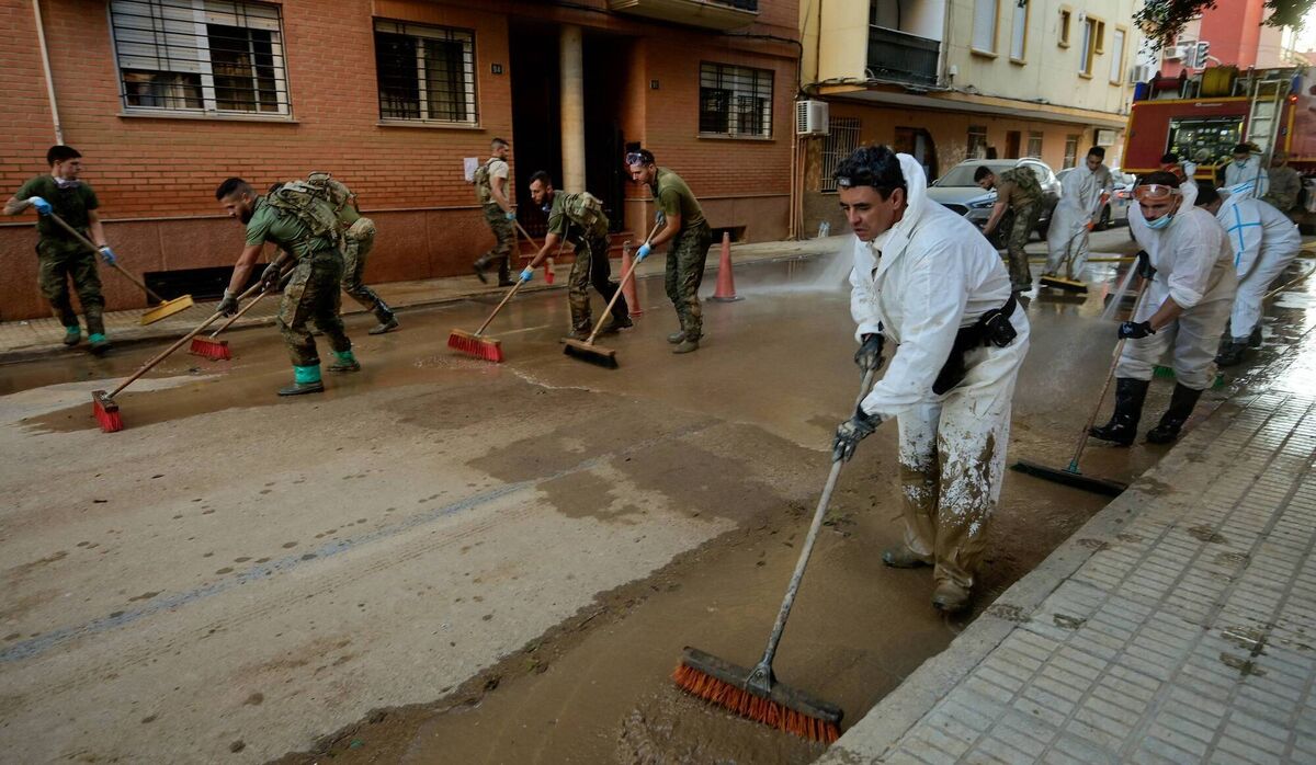 Military personnel clean a street in Paiporta. Picture: José Jordan/AFP via Getty Images Military personnel clean a street in Paiporta. Picture: José Jordan/AFP via Getty Images
