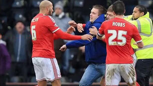 Derby fan punches Forest player on pitch, police arrest him