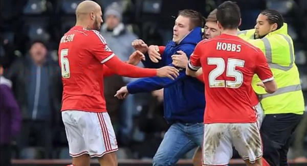 Derby fan punches Forest player on pitch, police arrest him