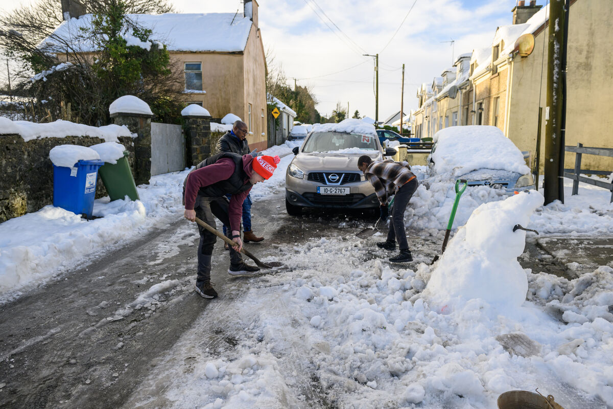  Looking to free their drive from snow were Evan, Manuel and Frank in Newmarket, Co Cork. Picture: Dan Linehan