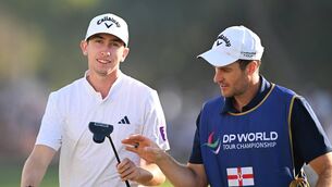 <p>Tom McKibbin with his caddie during the DP World Tour Championship. Picture: Ross Kinnaird/Getty Images</p>