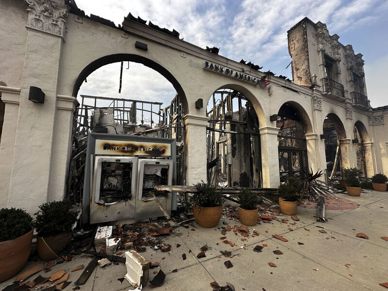 A fire-damaged Bank of America branch is seen after the Palisades Fire swept though in the Pacific Palisades neighborhood of Los Angeles, Wednesday, Jan. 8, 2025. (AP Photo/Eugene Carcia)