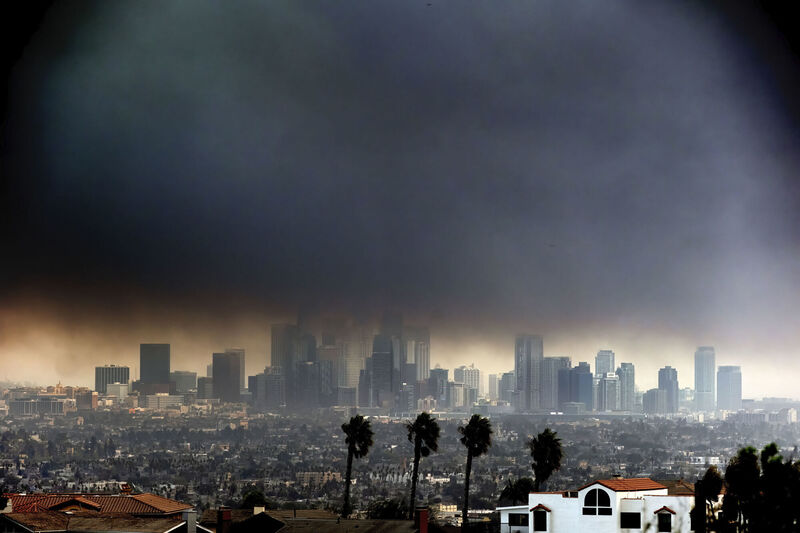 Thick heavy smoke from wildfires shrouds downtown Los Angeles on Wednesday, Jan. 8, 2025. (AP Photo/Richard Vogel)