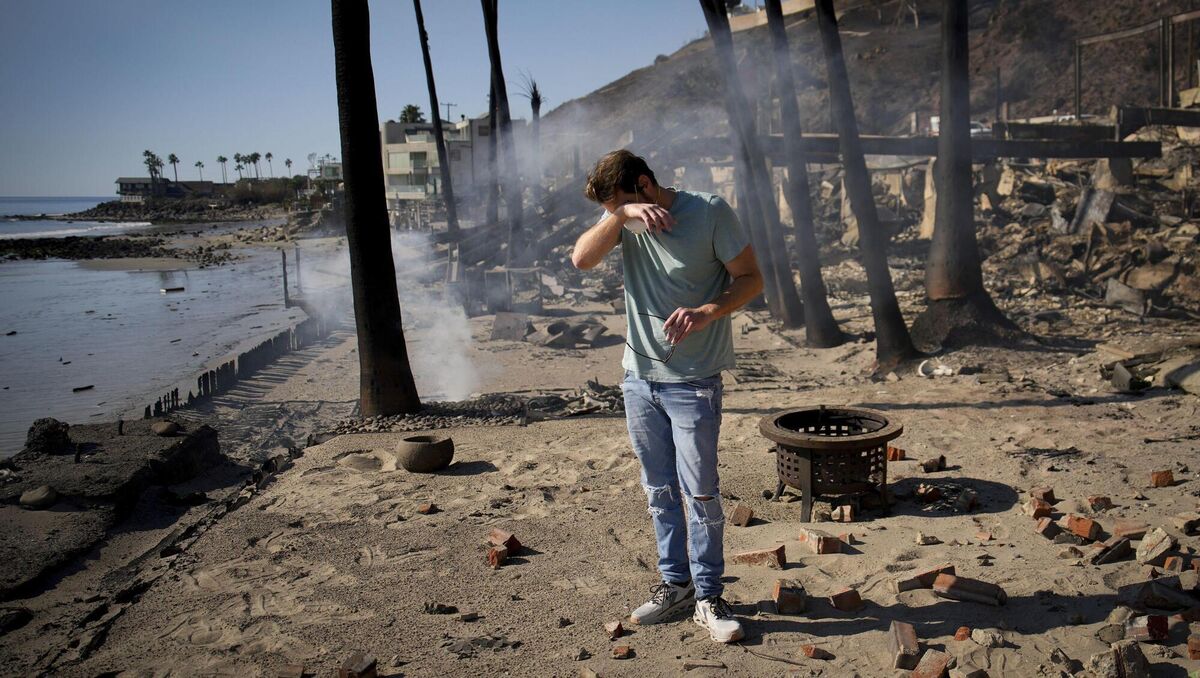 Luke Dexter reacts as he sifts through the remains of his father's fire-ravaged beachfront property in the aftermath of the Palisades Fire in Malibu, Calif. (AP Photo/John Locher) Luke Dexter reacts as he sifts through the remains of his father's fire-ravaged beachfront property in the aftermath of the Palisades Fire in Malibu, Calif. (AP Photo/John Locher)