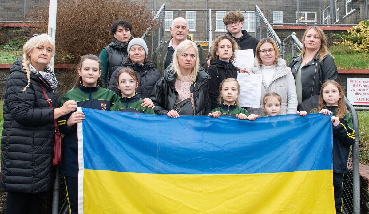 Greater Chernobyl Cause Charity founder Fiona Corcoran and Eoghan O'Neill, principal of Bun Scoil Mhuire, Youghal, with some of the Ukrainian families who have been served a notice to evict from the Quality Hotel.