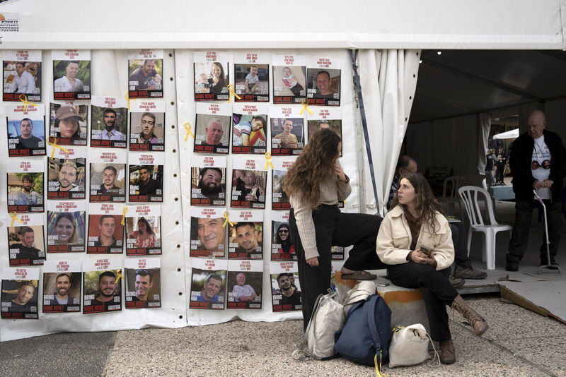 Women sit near posters of hostages held by Hamas in the Gaza Strip, in Tel Aviv, Israel Women sit near posters of hostages held by Hamas in the Gaza Strip, in Tel Aviv, Israel