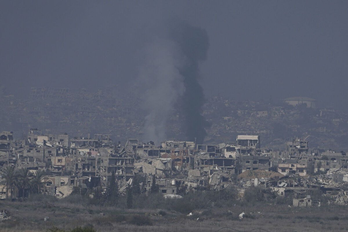 Smoke rises behind destroyed buildings by Israeli bombardments. (AP Photo/Tsafrir Abayov) Smoke rises behind destroyed buildings by Israeli bombardments. (AP Photo/Tsafrir Abayov)