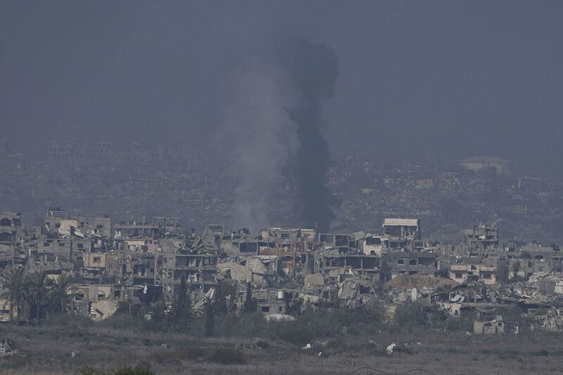 Smoke rises behind destroyed buildings by Israeli bombardments. (AP Photo/Tsafrir Abayov) Smoke rises behind destroyed buildings by Israeli bombardments. (AP Photo/Tsafrir Abayov)