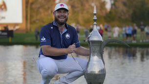 <p>Tyrell Hatton  poses with the trophy after winning the Dubai Desert Classic. Picture: Altaf Qadri/AP</p>