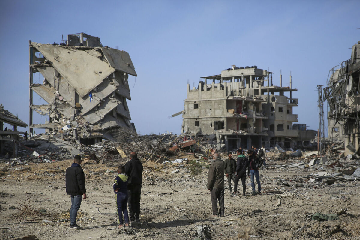 Palestinians stand amongst the destruction caused by the Israeli air and ground offensive. Picture: AP Photo/Mohammad Hajjar Palestinians stand amongst the destruction caused by the Israeli air and ground offensive. Picture: AP Photo/Mohammad Hajjar