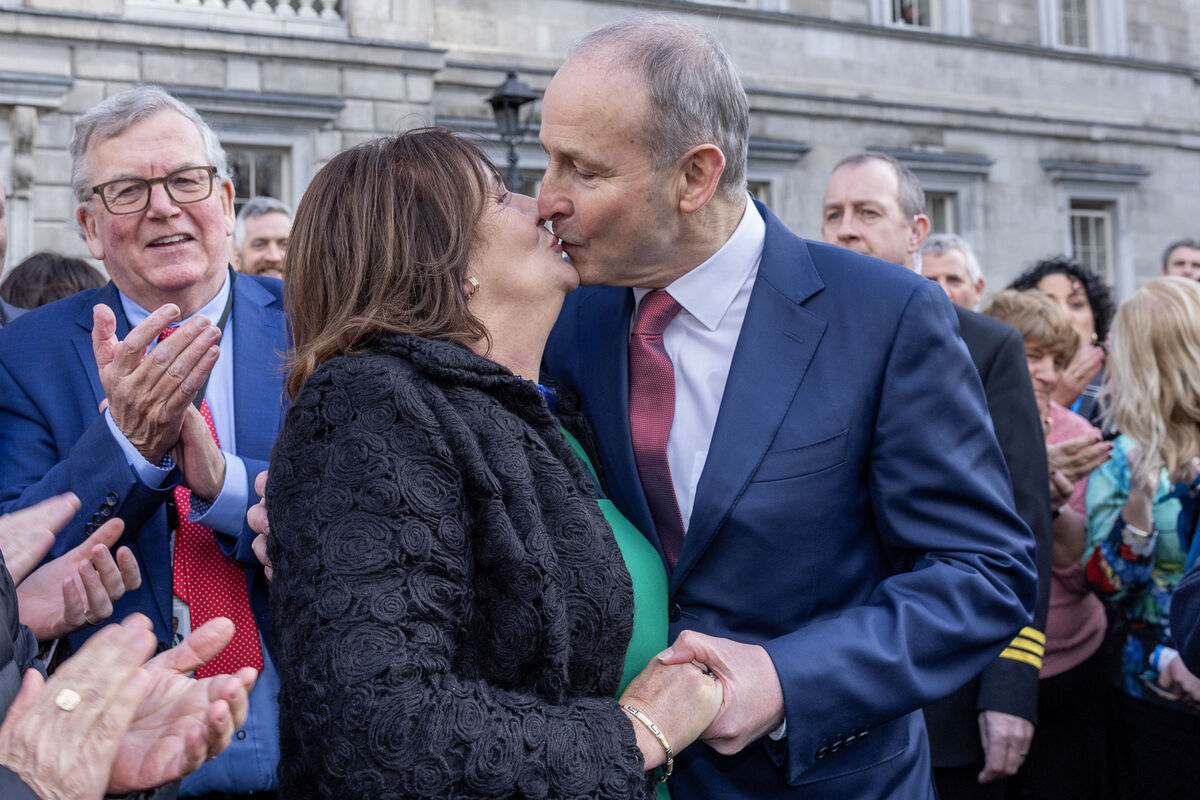 Micheál Martin kisses his wife, Mary, outside Leinster House, before heading to Áras an Uachtaráin to receive his seal of office. Picture: Maxwell's/PA Wire