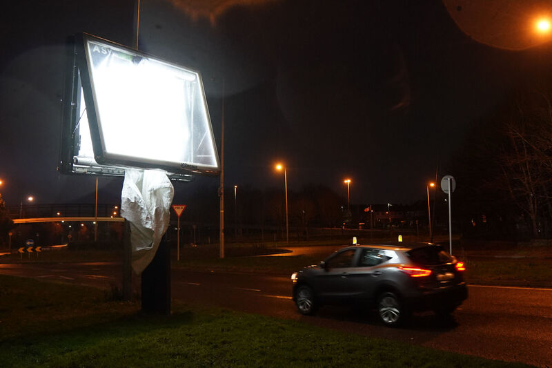 A car parses an advertising display damaged during Storm Eowyn in Finglas, Dublin. Picture: Brian Lawless/PA Wire