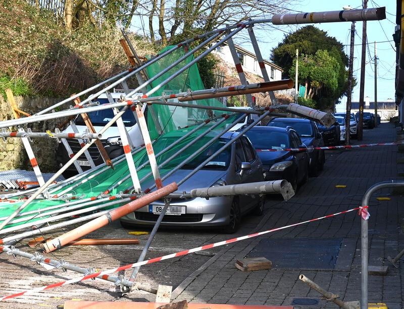 A fire brigade cordon in Cobh, Co Cork as the road and footpath remained closed for a number of hours on Friday morning after scaffolding was blown over onto a parked car following strongs winds and gusts overnight during Storm Éowyn. Picture: Larry Cummins