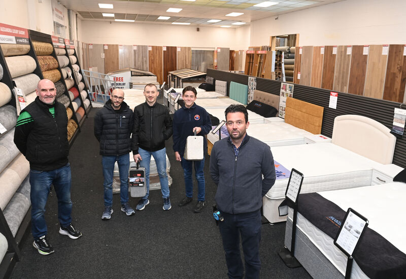  Ben Warrilow with staff in the showroom at Factory Carpet Superstores.