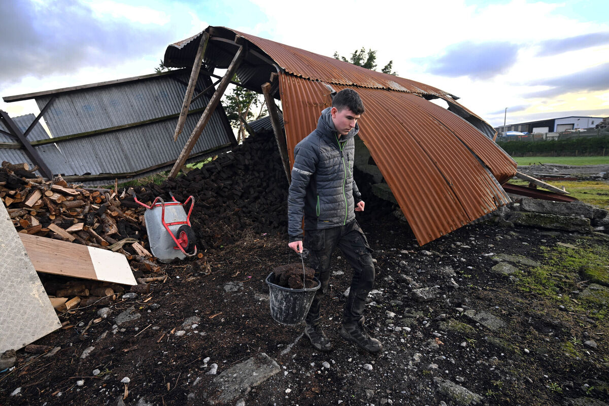 Mike Shaughnessy from Tuam gathering firewood and turf which was stored in a farm shed built in 1965 that was destroyed by Storm Éowyn. Picture: Ray Ryan
