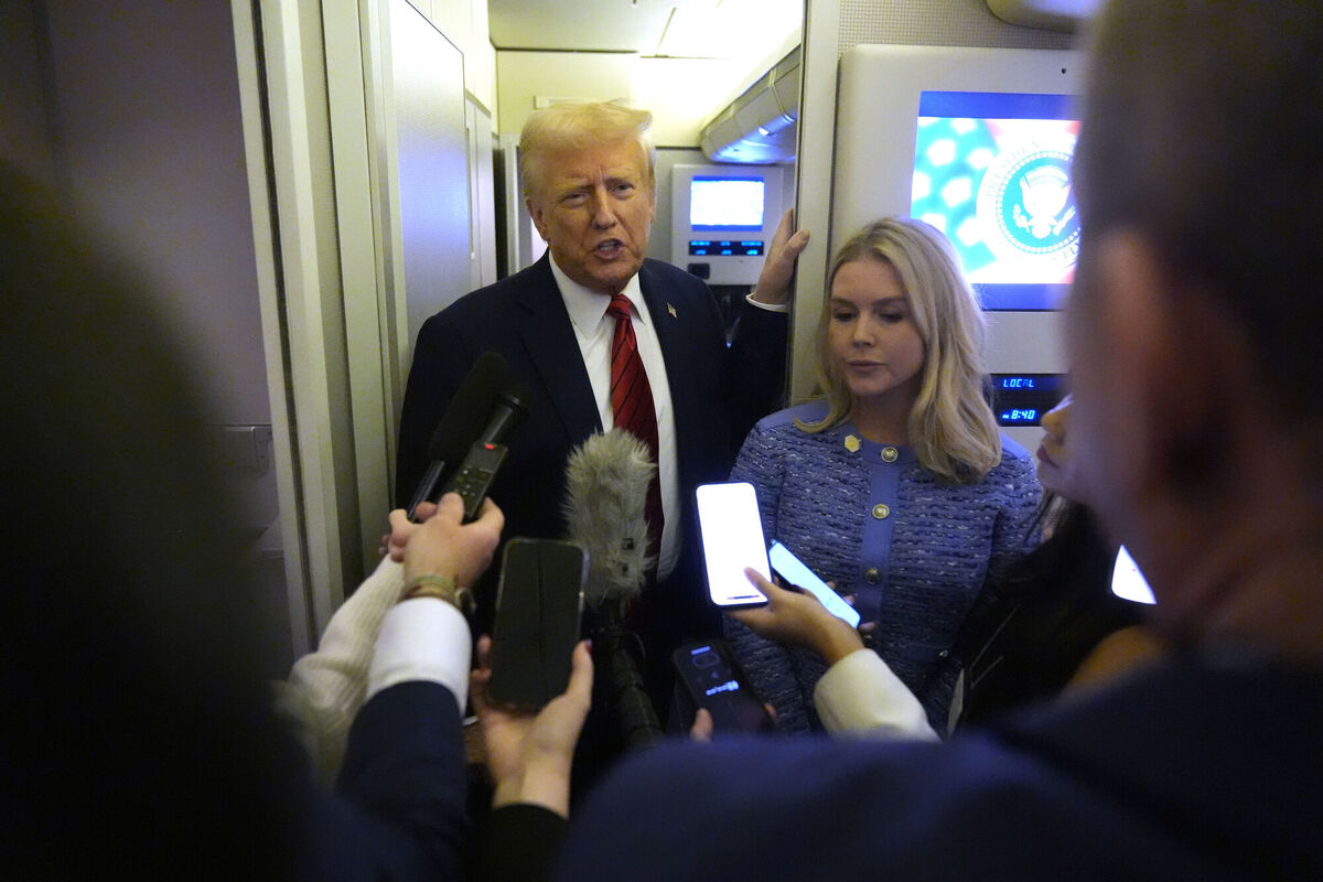 President Donald Trump speaks to reporters aboard Air Force One en route from Miami to Joint Base Andrews, Md., Monday, Jan. 27, 2025, as White House press secretary Karoline Leavitt listens. Picture: AP Photo/Mark Schiefelbein