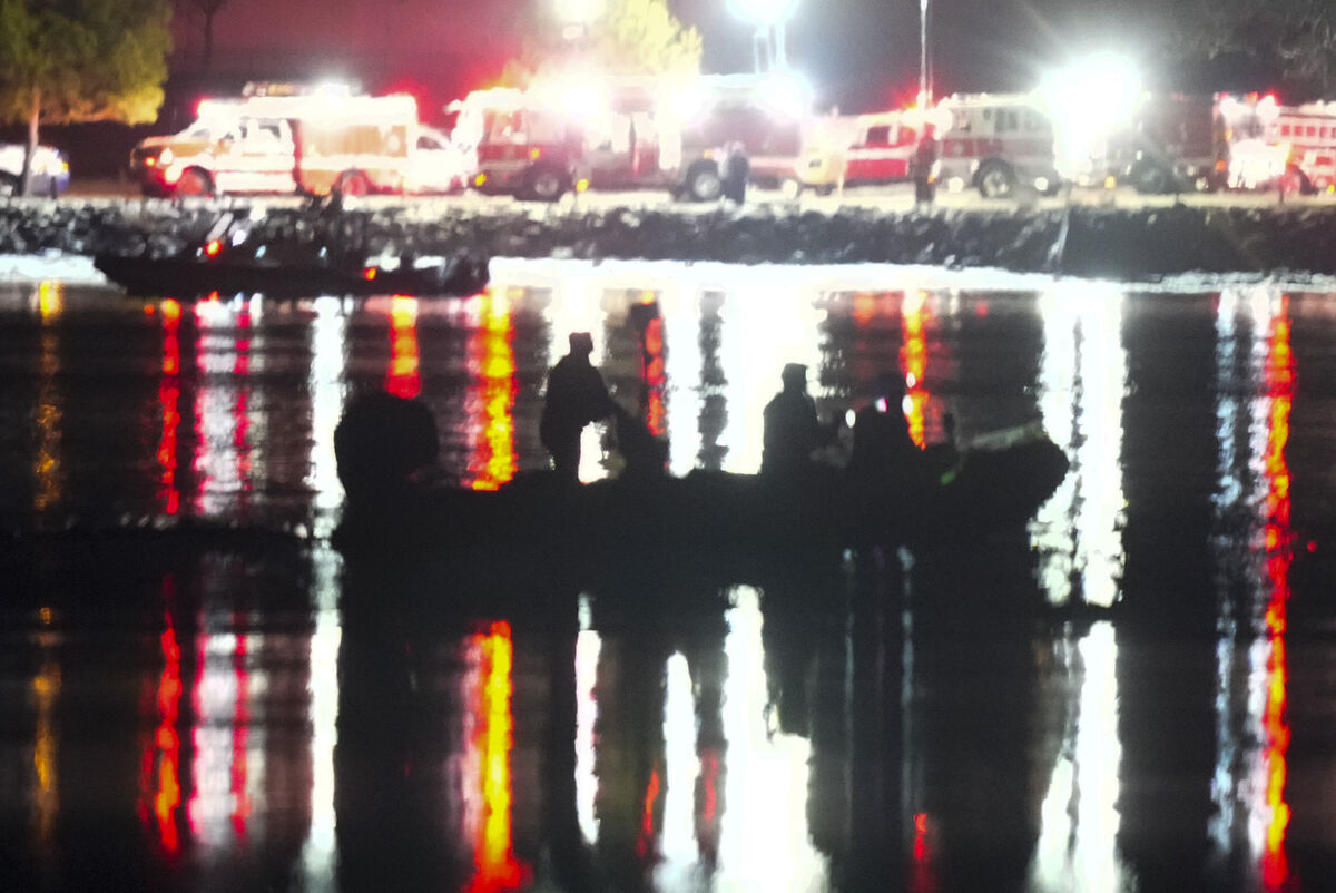 A boat works the scene in the Potomac River near Ronald Reagan Washington National Airport, Thursday, Jan. 30, 2025, in Arlington, Va. (AP Photo/Alex Brandon)