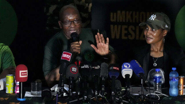 Duduzile Zuma-Sambudla, right, listens as her father speaks at a press conference in Soweto, South Africa (Themba Hadebe/AP)