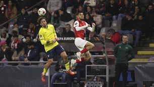 <p>Lazio's Luca Pellegrini, left and Braga's Gabri Martinez jump for the ball</p>