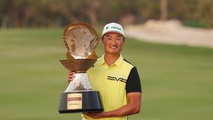 <p>Haotong Li of China poses with the winners trophy following day four of the Commercial Bank Qatar Masters at Doha Golf Club. Pic: Warren Little/Getty Images</p>