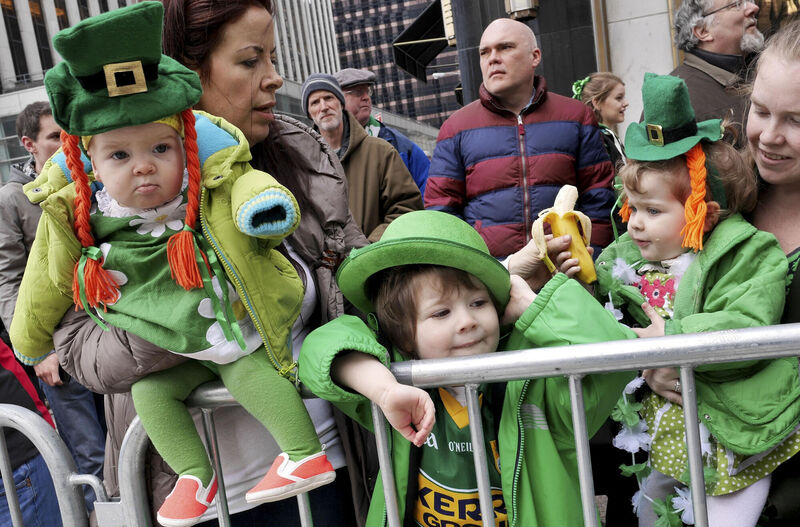 The O'Grady children, Billie, Austin, and Zola, enjoying the 2015 St Patrick's Day Parade in New York City. Picture: Seth Wenig/AP