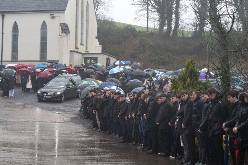Mourners line the road to St John’s Baptist Church in Lombardstown, Co Cork as a mark of respect for jockey Michael O'Sullivan. Picture: Chani Anderson Mourners line the road to St John’s Baptist Church in Lombardstown, Co Cork as a mark of respect for jockey Michael O'Sullivan. Picture: Chani Anderson