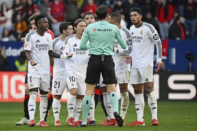 Real Madrid's players remonstrate with the referee about the red card presented to Real Madrid's English midfielder Jude Bellingham, right. Real Madrid's players remonstrate with the referee about the red card presented to Real Madrid's English midfielder Jude Bellingham, right.