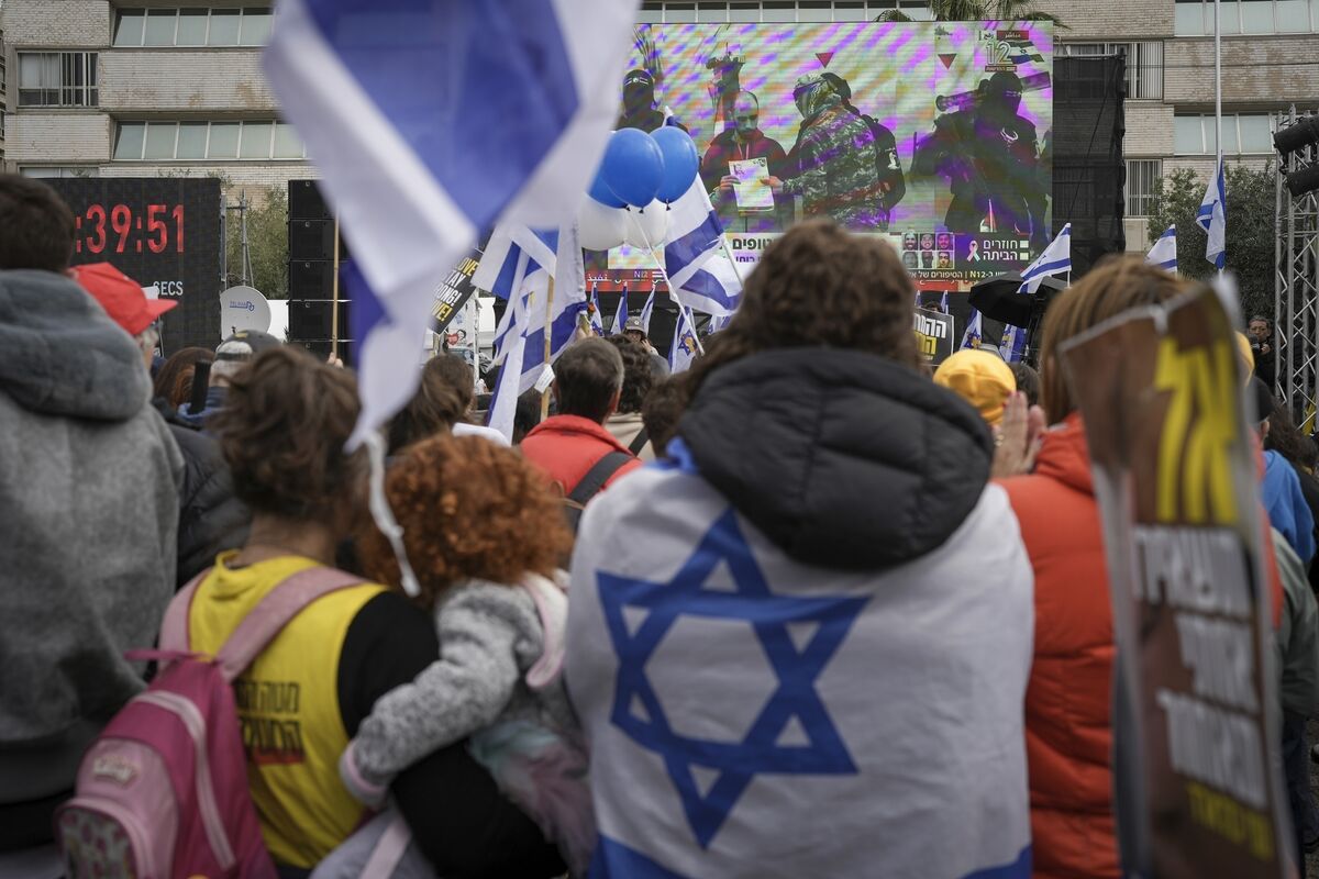 Israelis in Tel Aviv watch a live broadcast as the first two of six hostages to be released in Gaza by Hamas militants are handed over to the Red Cross Picture: Oded Balilty/AP