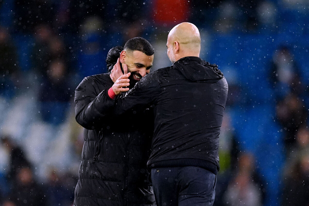 Manchester City manager Pep Guardiola with Liverpool's Mohamed Salah. Pic: Martin Rickett/PA Wire.