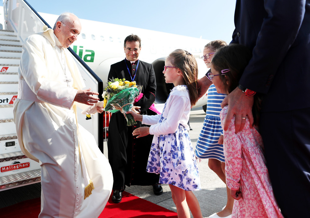 Pope Francis arrives in Ireland for the 2018 World Meeting of Families. He is greeted on arrival at Dublin Airport by Tánaiste and Minister for Foreign Affairs and Trade, Simon Coveney T.D., and his wife Ruth, along with their three daughters Beth (9), Jessica (7) and Annalise (5). Pictured is Jessica, handing flowers to Pope Francis.