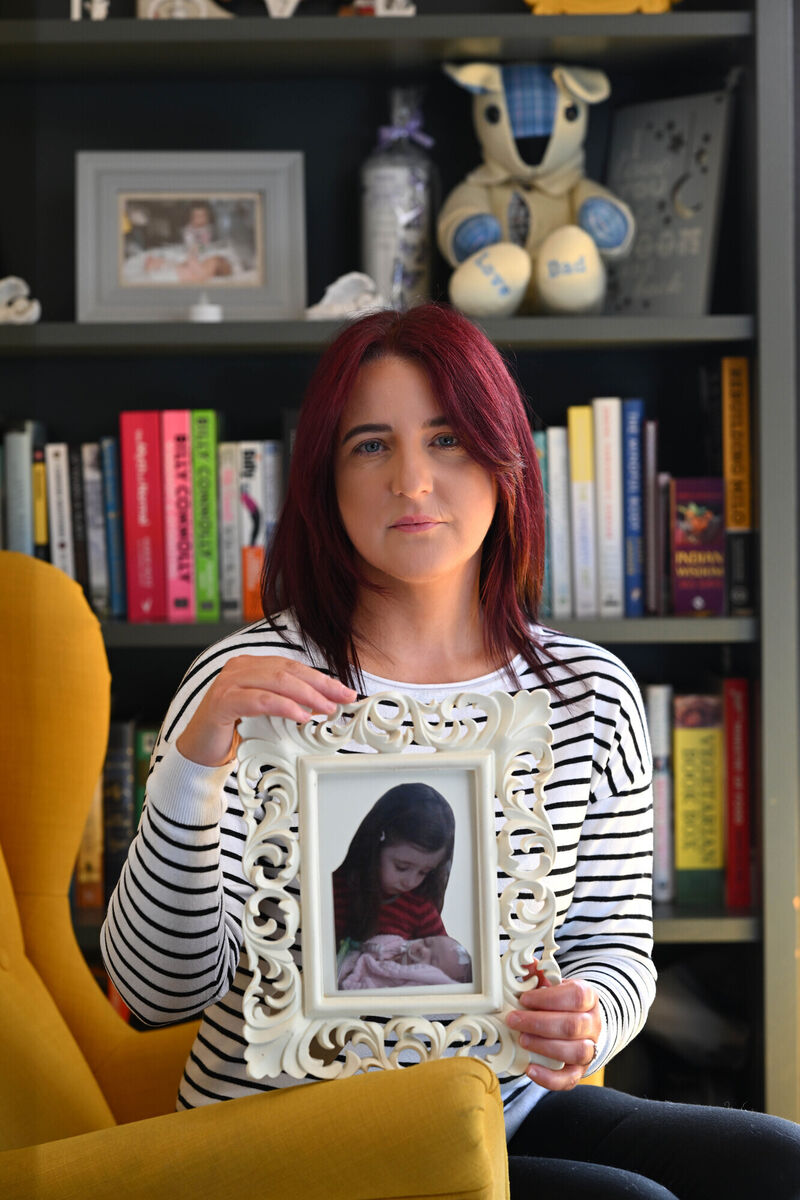 Lorraine with a picture of her daughter Angel holding baby Amber. Picture: Ray Ryan