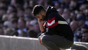 Ruben Amorim crouches down on the touchline (Peter Byrne/PA)