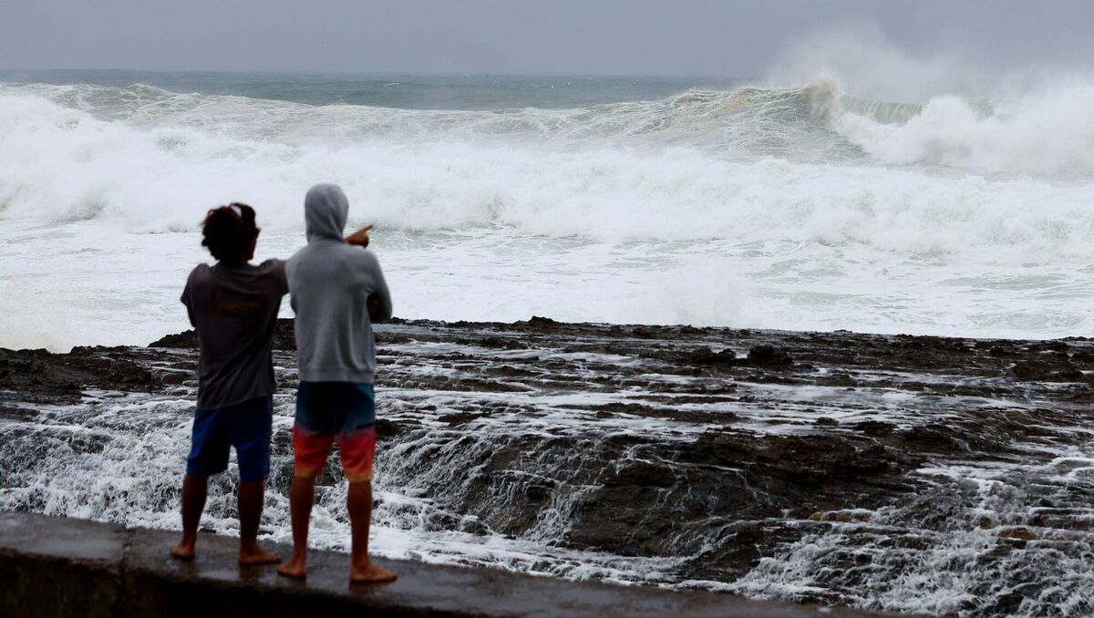 People watch the large waves at Snapper Rocks in the Gold Coast ahead of Tropical Cyclone Alfred. Picture: Chris Hyde/Getty Images
