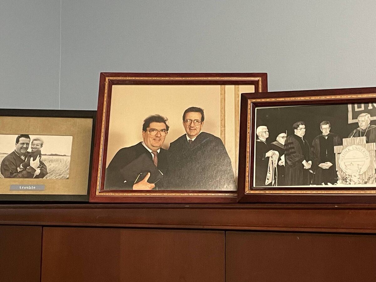 On a bookshelf in the office of Boston immigration lawyer, Brian O'Neill, are treasured photos of him with John Hume. 