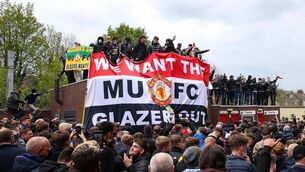 <p>UNITED IN RADE: Fans hold up banners as they protest against the Glazer family, owners of Manchester United, before their Premier League match against Liverpool at Old Trafford, Manchester. Issue date: Sunday May 2, 2021.</p>
