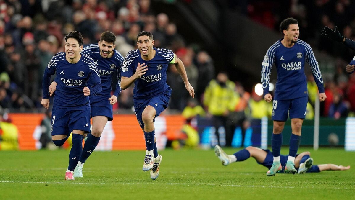 RUNNING TO THEIR HERO: Paris Saint-Germain's Achraf Hakimi (centre left) and team-mates celebrate winning the penalty shoot-out after the UEFA Champions League round of sixteen second leg match at Anfield, Liverpool. Pic: Martin Rickett/PA Wire