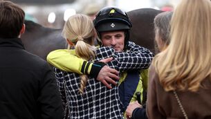 <p>DEEP MEANING: Sean Flanagan hugs the late Michael O’Sullivan’s girlfriend Charlotte Giles after winning the Queen Mother Champion Chase on Marine Nationale</p>