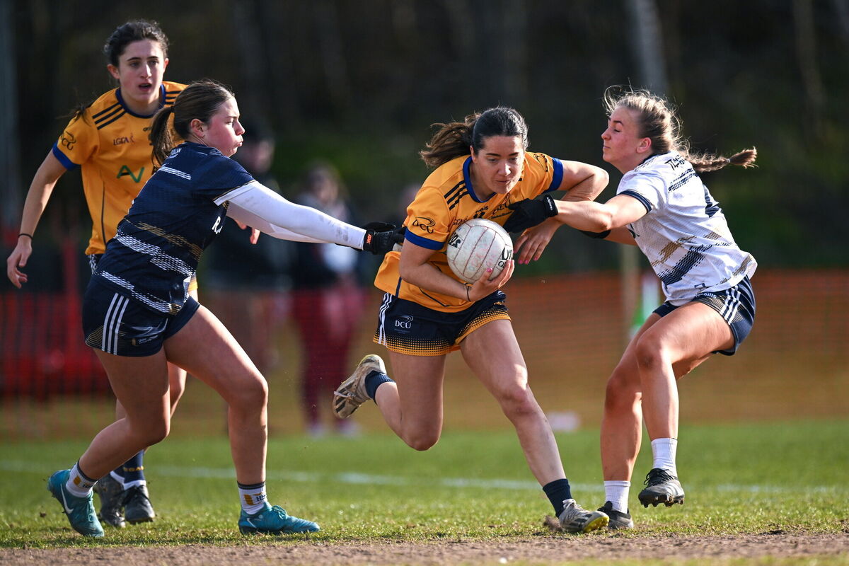 Leah Fox of DCU DÉ is tackled by UU Belfast players Cara Bradley, left, and Maeve Ferguson. Pic: Shauna Clinton/Sportsfile