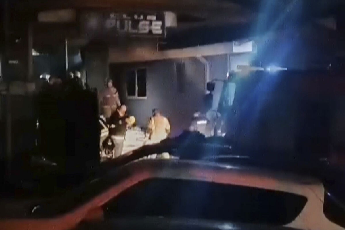 Rescue workers stand in front of a club after massive fire broke out early Sunday in Kocani, North Macedonia, March 16, 2025. Picture: Kocani TV via AP