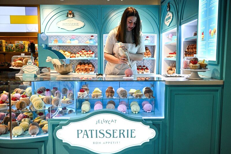An employee prepares a Jellycat pastry-shaped soft toy at Galeries Lafayette Haussmann in Paris. Picture: Julien De Rosa/AFP via Getty Images