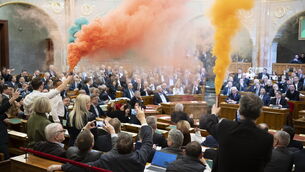 <p>MPs protest with flares during the plenary session of the Hungarian parliament in Budapest, Hungary, on Tuesday. Picture: Boglarka Bodnar/MTI via AP</p>