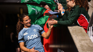 <p>HERO'S WELCOME: Emily Lane high-fives students from Dundonald Primary School on her way out the tunnel. Pic: INPHO/Ben Brady</p>